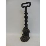 A late Victorian cast iron door stop in the form of a stylised paw, 13 1/2" high.