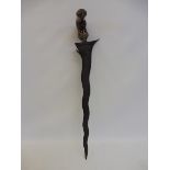A 19th Century Indonesian kris with carved bird's beak handle, 18" long.