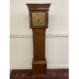 An oak carved eight day longcase clock with a square brass dial bearing the name David Scott 1926.
