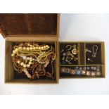 A jewellery box containing a small amount of jewellery including a 9ct gold pendant, an amethyst