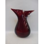 A stylish ruby glass vase.