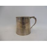 A Georgian silver tankard of plain form, London 1819, maker slightly rubbed, possibly RP.