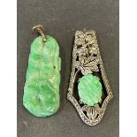 An Art Deco and marcasite encrusted scarf clip set with a carved oval piece of jade plus a carved