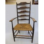 A 19th Century ash ladderback armchair with rush seat.