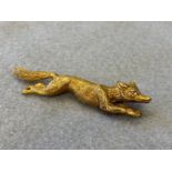 A 15ct gold brooch in the form of a running fox, approximately 12g.