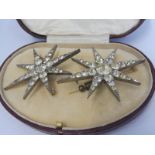 A superb pair of cased star-shaped paste encrusted brooches with excellent shine.