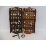 A silver candlestick plus a collection of collectable spoons, some white metal, also a Scout