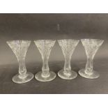 Four high quality matching drinking glasses with engraved and faceted design.