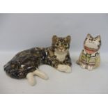 A Winstanley recumbant cat plus a Rye 1986 glazed pottery seated cat figure.