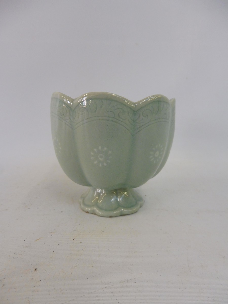 A Chinese celadon pedestal cup, 3" high.