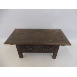 A miniature carved wooden chest.