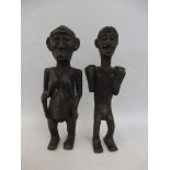 A pair of very unusual and early tribal bronze figures.