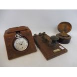 A heavily carved watch stand, a travel inkwell and a morse code machine.