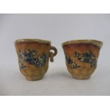 Two Chinese terracotta cups with ring handles.