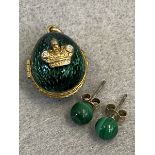 A yellow metal, probably gold, egg shaped locket in green lattice work design enamel, mounted to the