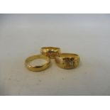 Three 18ct gold rings, two inset with diamonds.