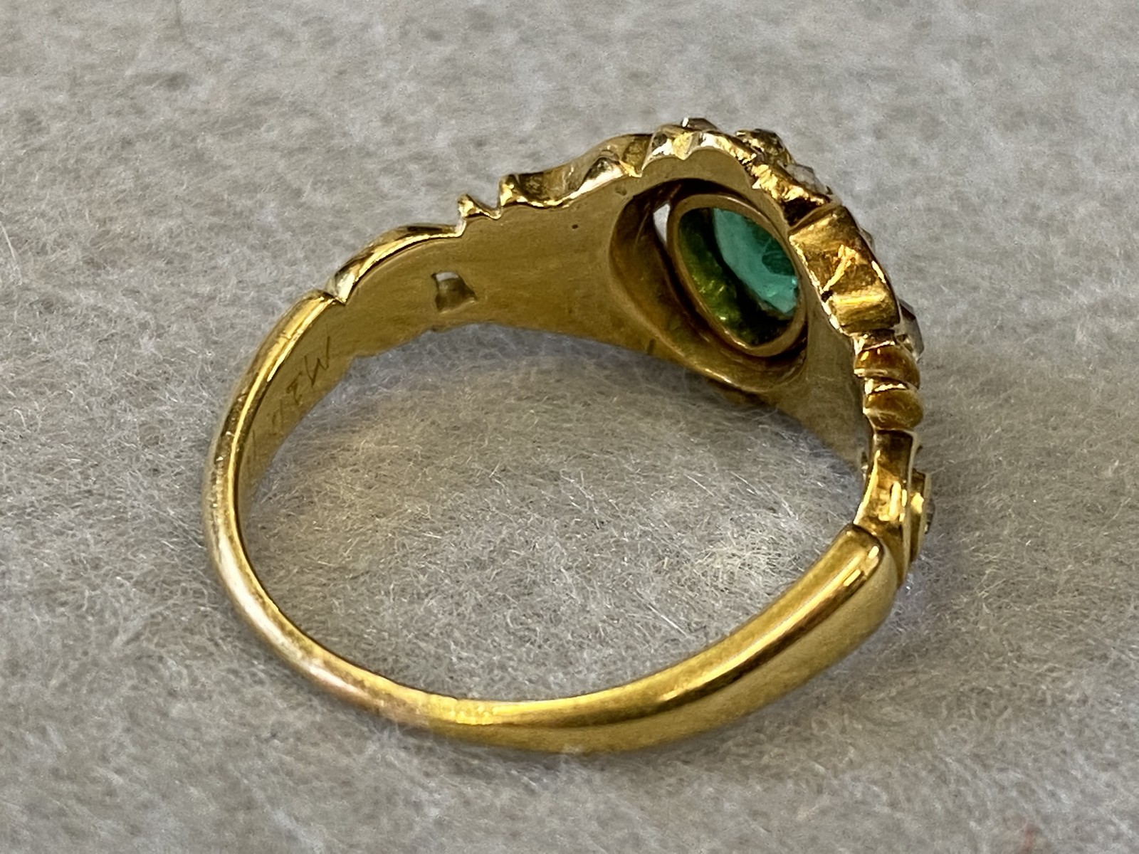 An unmarked gold ring set with a central emerald accompanied by diamonds plus a 9ct gold slender - Image 2 of 3