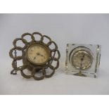A brass ring clock and one other.