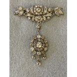 A Victorian or earlier diamond encrusted brooch with articulated wings and oval hanging detachable