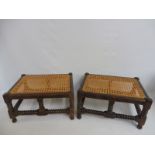 A pair of rectangular cane seated stools with bobbin turned stretchers.