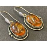 A pair of silver mounted amber earrings.
