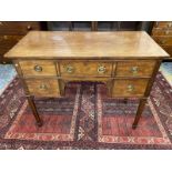 A 19th Century mahogany and rosewood strung dressing table of three drawers raised upon square