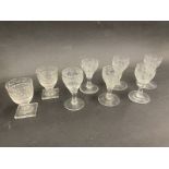 Six early cut glass tot glasses with finely engraved decoration and two others.