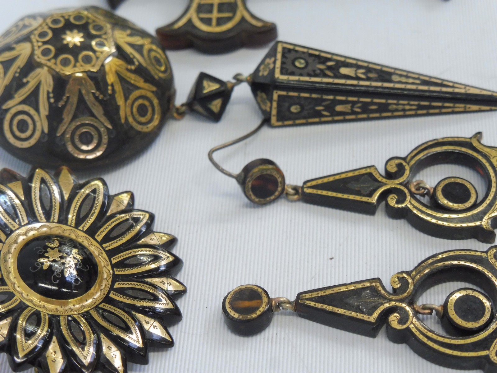 A tortoiseshell and yellow metal inset flower shaped brooch, an unusual Persian style circular - Image 2 of 3