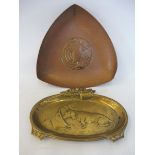 An Arts & Crafts hammered copper dish depicting a spread eagle, together with a brass card tray