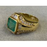 A Continental gold ring set with a central square emerald surrounded by diamonds of different cuts.