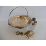 A large silver plated basket, a silver cigarette case, a silver topped bottle etc.