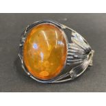 An Art Nouveau silver bracelet inset with a very large oval piece of amber, marked .925.