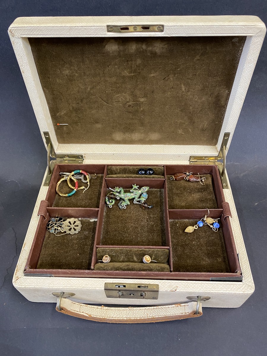 Six pairs of earrings, and a brooch in the form of a chameleon, in a multi-layered jewellery box.