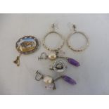 A quantity of silver earrings and brooches.