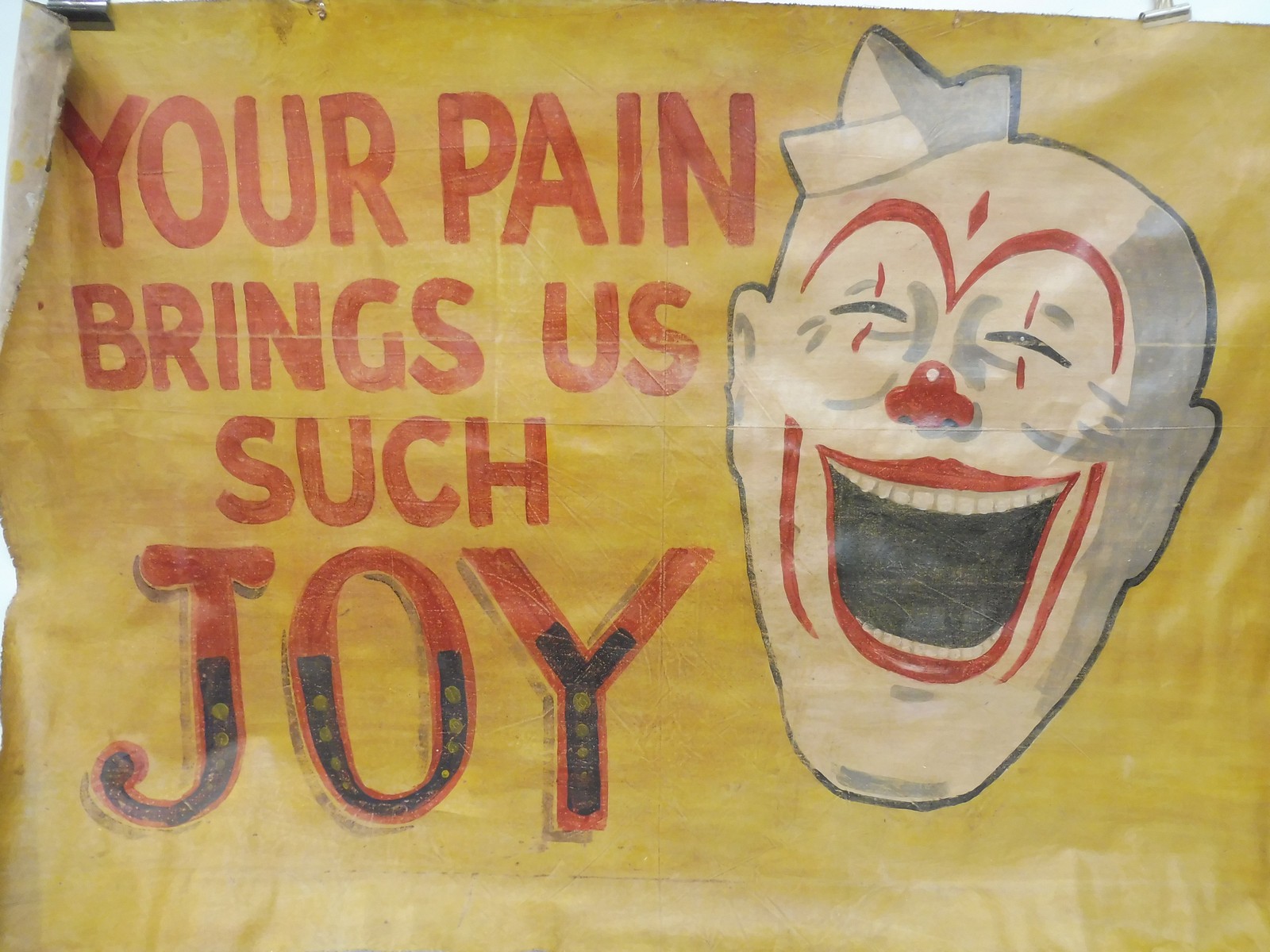 An original 'House of Horrors' artwork canvas banner, in the form of a clown, 61 x 42".