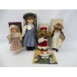A quantity of Alberon collectors' porcelain dolls on stands, plus a catalogue of Alberon dolls dated