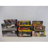 A small collection of boxed racing cars of different eras.