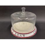 A Wright & Son's Chocolate Wafers pottery circular display stand with a glass dome, 8 x 7".