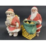 Two Father Christmas figural sweet shop containers, the largest 10" tall.