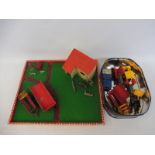 A farm play board with building, figures and accessories.