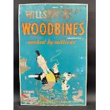 A Wills's Woodbines pictorial tin advertising sign depicting a comical character smoking a cigarette