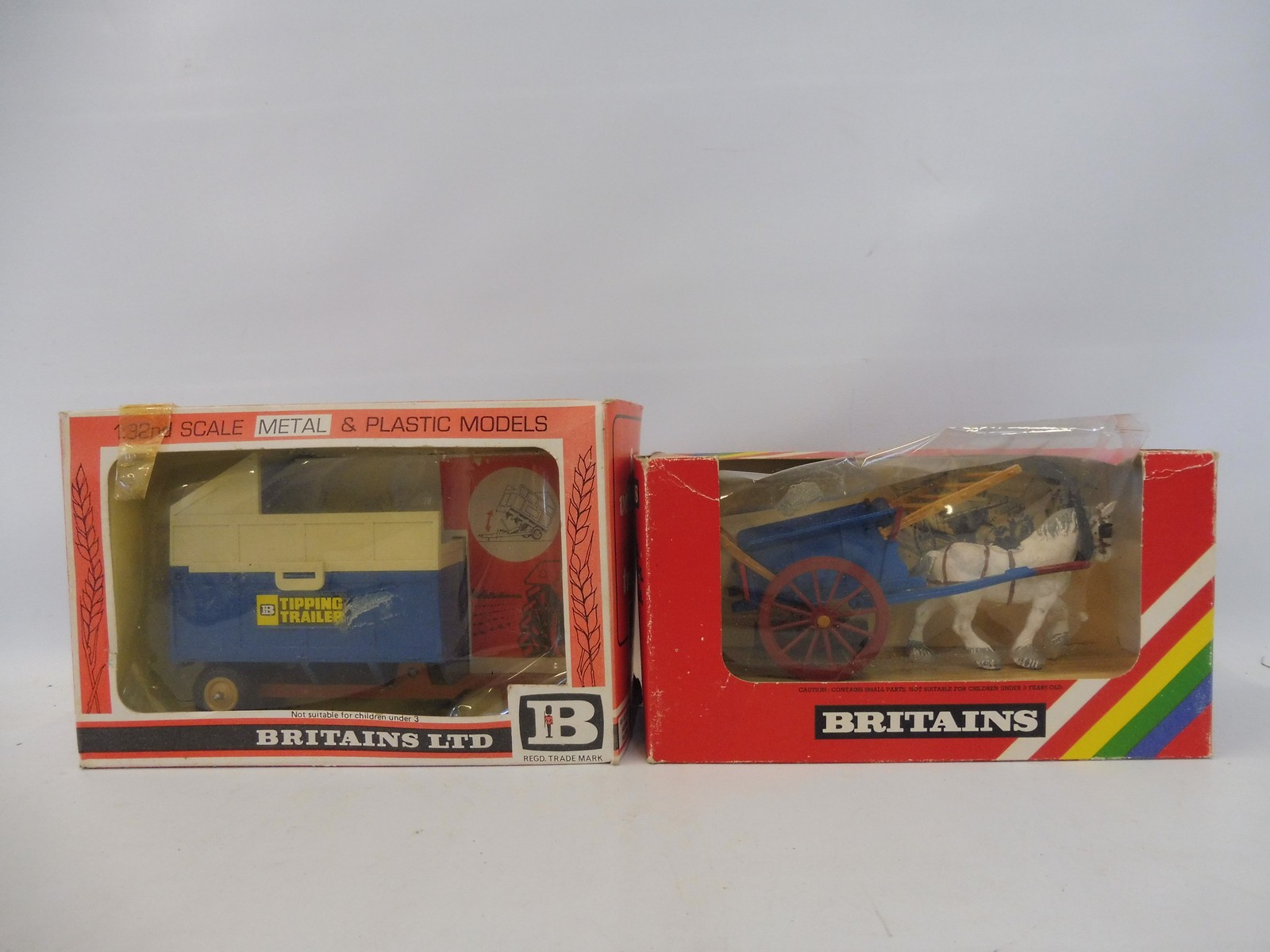 Two boxed Britains: no. 9499 and 9566 Tumbrel Cart and Tipping Trailer, generally good condition