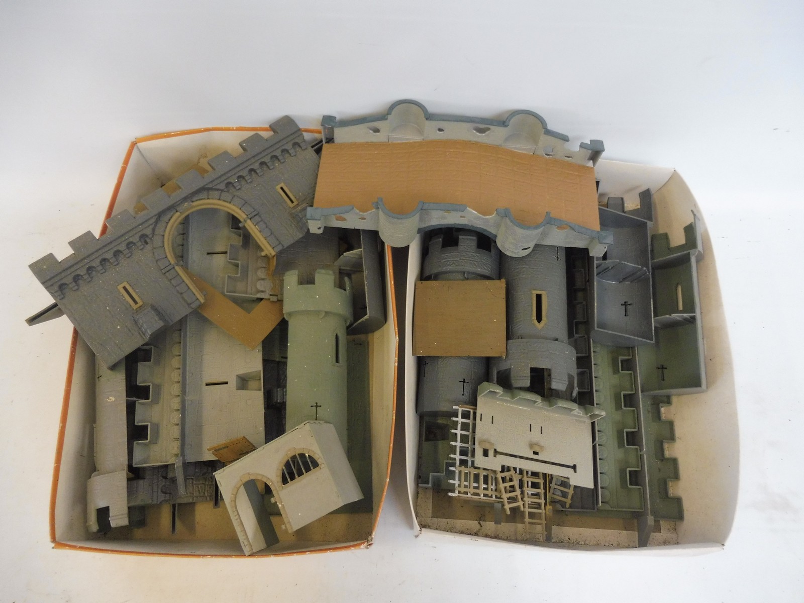 Two boxes full of Airfix Medieval castles, overpainted.