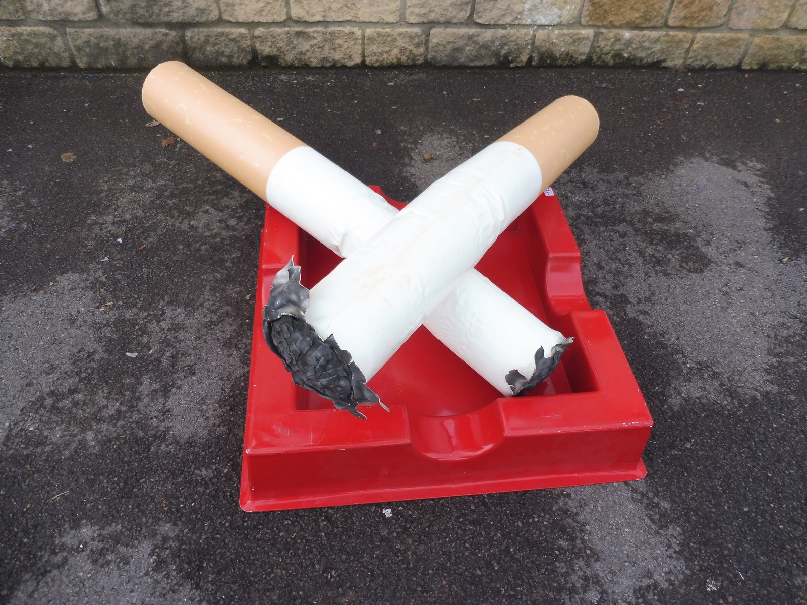 A large scale novelty advertising carnival pair of oversized cigarettes and ashtray.