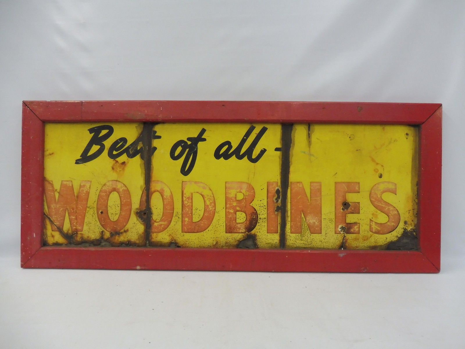 A 'Best of All Woodbines' rectangular enamel sign in a wooden frame, 50 x 20".