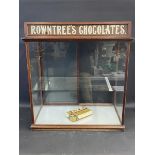 A mahogany shop counter rear opening dispensing cabinet with single glass shelf, and Rowntree's