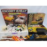 A box of various eras Scalextric cars, accessories and track.