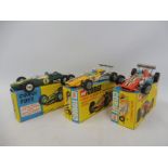 Three boxed Corgi racing cars: Lotus Climax 153 in green livery, Lotus Climax in red livery with