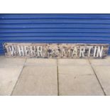 An early wooden garage sign for Wherry & Martin, possibly from the Cheltenham area, 78 x 12".