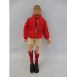 An original 1970s Action Man figure, with blond flock hair, in a complete Manchester United football